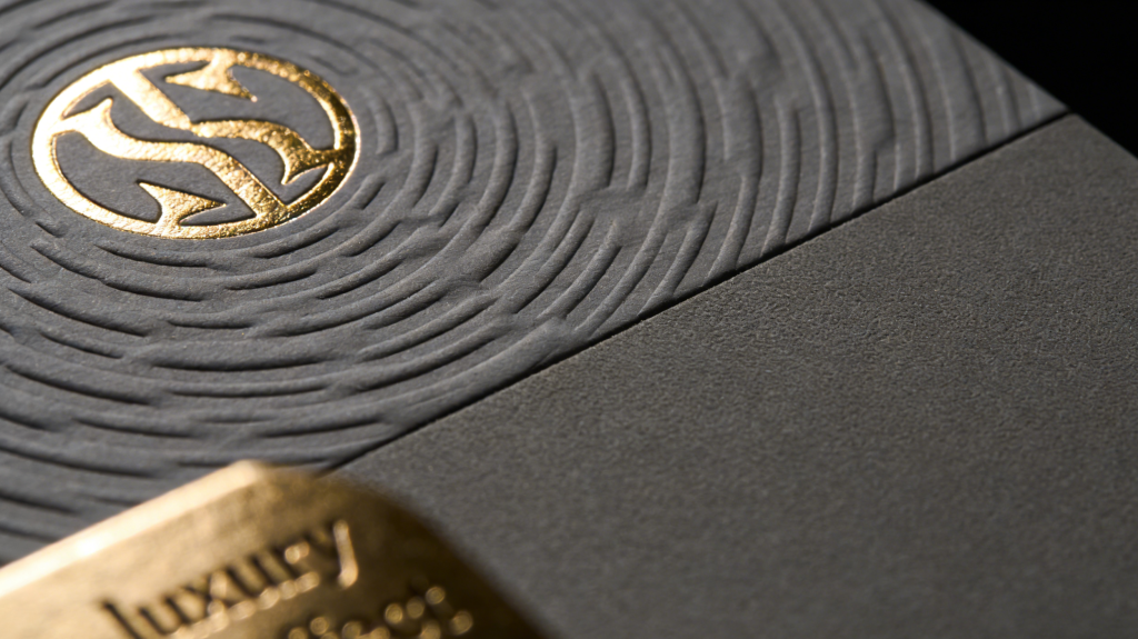 Close-up of luxury rigid box surface with gold foil stamping, embossing texture, and soft-touch laminated finish